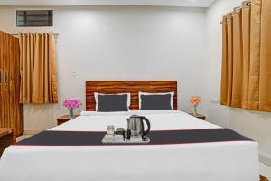 a bedroom with a large bed with a blender on it at FabHotel Adiyogi Aura in Indore