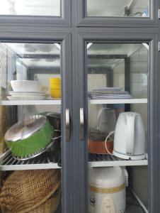 a refrigerator filled with lots of dishes and appliances at Mer Bleue Homestay Phòng Family in Ke Ga