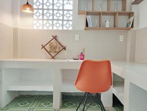 a kitchen with a desk and a red chair at Mer Bleue Homestay Phòng Family in Ke Ga +37 photos