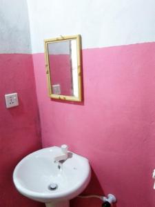 a bathroom with a sink and a mirror at Fr Resort in Arugam Bay