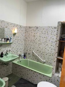 a bathroom with a green tub and a sink at Cottage With 400 M To The Water And The Marina in Østerby Havn