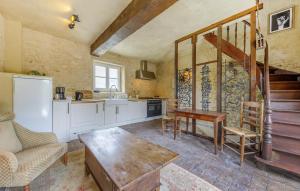 a kitchen with a table and a refrigerator at Charmant Gîte En Campagne in Palluau-sur-Indre +25 photos