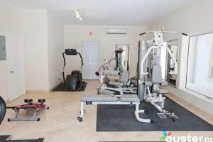 a gym with tread machines and a treadmill at LUXURY VILLA Grace Bay Beach in Long Bay Hills
