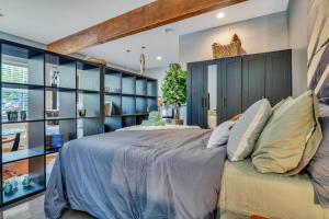 a bedroom with a large bed with blue shelves at Eva's Zen House Downtown ATL Retreat in Atlanta