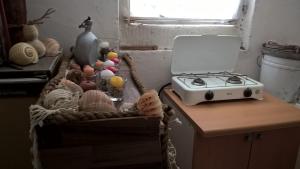 a table with a stove and a basket of food at Holiday home Stiniva in Vis