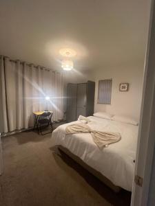 a bedroom with a bed and a table in it at Golden House in Waterbeach