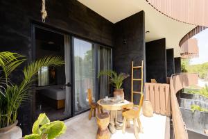 a room with a table and some plants at "Designer Cave Loft" in Tulum Hotel Zone - Beach Club included in Tulum