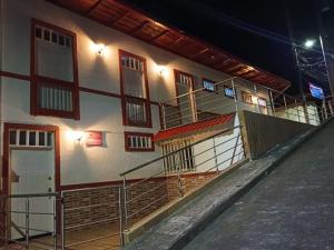 a building with stairs on the side of it at night at Apartaestudios Santa Ana in Ruiosucio