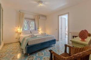 a bedroom with a bed and a window and a desk at Luxury Villa Flaminia, 50 mt from the beach in Santa Margherita di Pula
