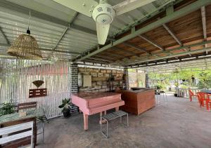 a room with a pink piano and a table at Phum Khnhom Bungalow in Battambang +58 photos