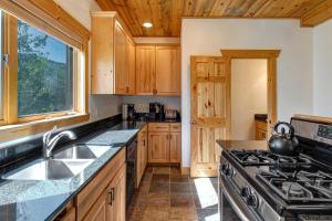 a kitchen with wooden cabinets and a stove top oven at Timber Wolf Lodge 7C condo in Park City +28 photos