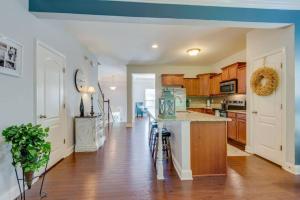 a kitchen with wooden cabinets and a counter top at Cheerful Nashville Home In Hip Westmeade! in Nashville
