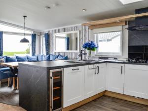 a kitchen with white cabinets and a counter top at Solway Heights 7 - Uk43974 in Mainsriddle