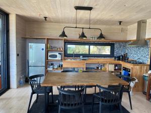 a kitchen with a large wooden table and chairs at Calm and beautiful beach in Pichilemu