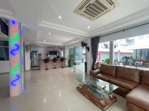 a living room with a couch and a glass table at W-9 Hotel in Nong Prue