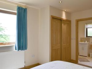 Postel nebo postele na pokoji v ubytování Hazel Lodge