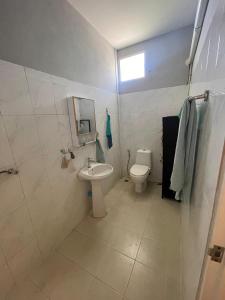 a bathroom with a toilet and a sink at Deli Devi Budget Home in Hinkong