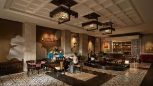 a lobby with people sitting at a bar at The Odys Boutique Hotel in Ho Chi Minh City