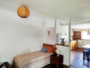 a bedroom with a bed and a table in a room at Nalu Nalu Hostel in San Juan del Sur