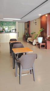 a group of tables and chairs in a room at JRJA Suites 1 near Card Bank Tagum in Tagum