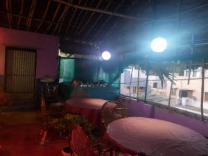 a restaurant with two tables and chairs and a window at UmaNatarajan Residency in Tiruvannāmalai +37 photos