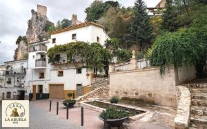 a white building on a hill with a house at Casa La Abuela 1982 in La Iruela