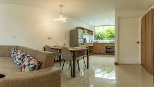 a kitchen and dining room with a table and chairs at Sweet Dreams the Arenal in Fortuna