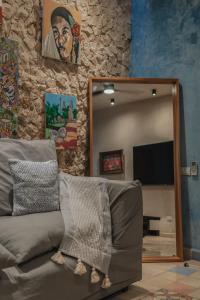 a mirror in a living room with a couch and a television at Wotoch Azul in Mérida