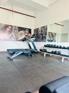 a gym with two rows of dumbbells in a room at Sea view Serenity Negombo in Negombo