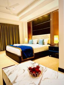 a hotel room with a large bed and a table at Sea view Serenity Negombo in Negombo