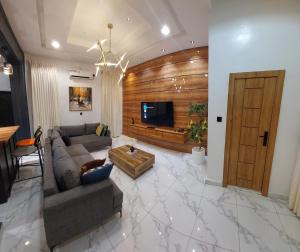 a living room with a couch and a tv at 2 bedroom apartment lekki Gardens in Ajah in Ikate