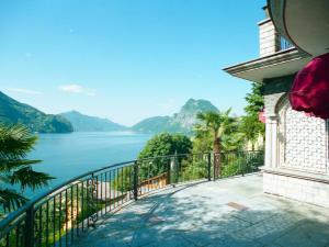 a balcony of a house with a view of the water at Barony romantic villa in Lugano