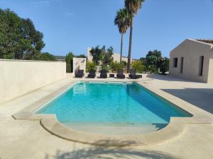 a swimming pool in the middle of a patio at Finca Sol y Mar Es Trenc in Campos