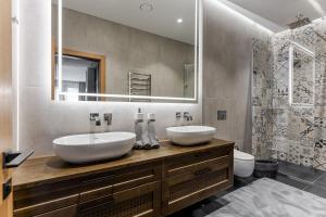a bathroom with two sinks and a mirror at Luxury apartment in the city center Nr3 in Kaunas +17 photos