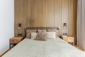 a bedroom with a large bed with two night stands at Luxury apartment in the city center Nr3 in Kaunas