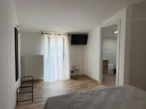 a bedroom with a bed and a window at B&b da Chiazza in Cicala
