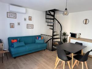 a living room with a blue couch and a table at B&b da Chiazza in Cicala
