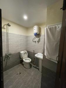 a bathroom with a toilet and a sink at Your home, away from home in Humak