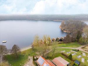 an aerial view of a lake with houses and trees at Ferienhaus mit Sauna im Ferienpark Mirow in Granzow +10 photos