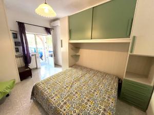 a bedroom with a bed and green cabinets at Appartamenti Miramare in Collina Sea-view Hillside in Ischia