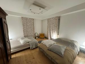 a bedroom with two beds and a window at Le Milpa LXXXVIII in Brouvelieures