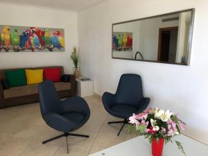 a living room with two chairs and a mirror at T2 & Garage FRONT DE MER résidence de Standing in Fréjus