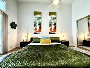 a bedroom with a large green bed in it at Modern Folsom Family Home Near Trails & Shopping in Folsom