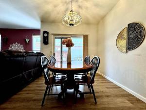 a dining room with a table and chairs and a couch at Modern Folsom Family Home Near Trails & Shopping in Folsom