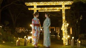 two women in kimonos standing in front of a sign at Hakone Yunohana Prince Hotel in Hakone