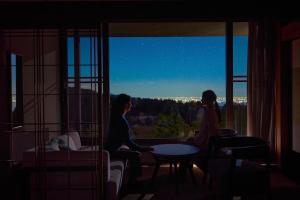 two women sitting at a table looking out of a window at Hakone Yunohana Prince Hotel in Hakone +57 photos