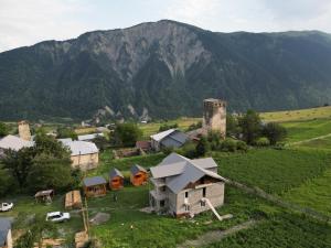 an aerial view of a farm with mountains in the background at Gugas cottage and guest house in Lakhiri in Lakhiri