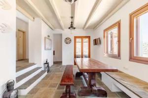 a large room with a wooden table in it at Marilia VIllage Spathi Kea "Villa Helios" in Spathi 
