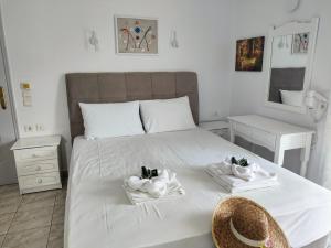 a bedroom with a bed with towels on it at Sirius in Syvota