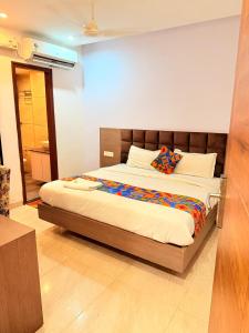 a bedroom with a large bed in a room at Hotel Melano Ambala Chandigarh Rd Zirakpur SkyJumper park in Zirakpur